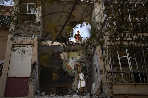 An Israeli soldier inspects a damaged residential building, a day after it was hit by a rocket fired from the Gaza Strip, in Rishon Lezion, Israel, Thursday, Oct. 26, 2023. (AP)