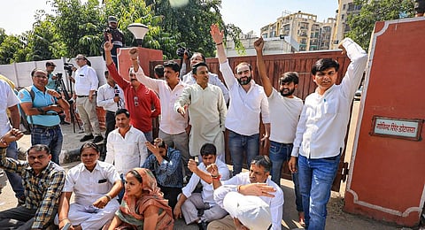 Congress workers shout slogans as they protest after the Enforcement Directorate'sraid at Rajasthan Congress President Govind Singh Dotasra's residence.(Photo | PTI)