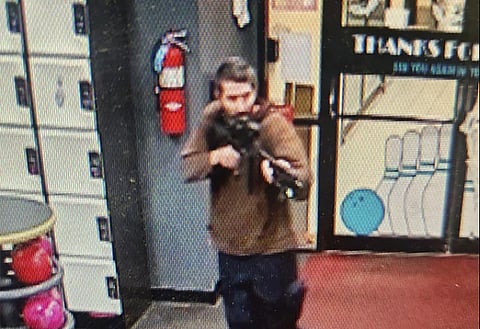 An unidentified gunman points a gun while entering Sparetime Recreation in Lewiston, Maine, on Wednesday, Oct. 25, 2023. (AP)
