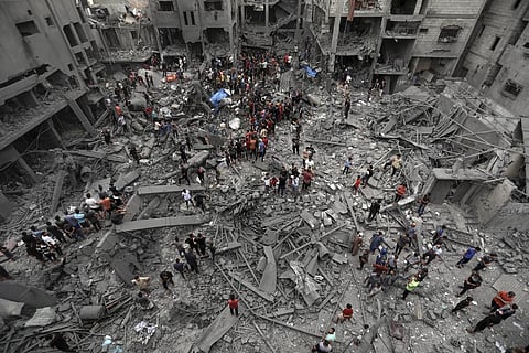 Palestinians inspect the damage of destroyed buildings following Israeli airstrikes on Gaza City, Friday, Oct. 27, 2023. (Photo | AP)