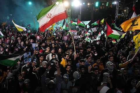 Iranian demonstrators wave Iranian, Palestinian and Lebanon's militant Hezbollah group flags in a pro-Palestinian rally at the Felestin Sq. in Tehran, Oct. 20, 2023. (Photo | AP)