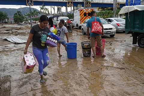 People carry away toilet paper, eggs and cereal from a grocery store after Hurricane Otis ripped through Acapulco, Mexico, Wednesday, Oct. 25, 2023. (Photo | AP)