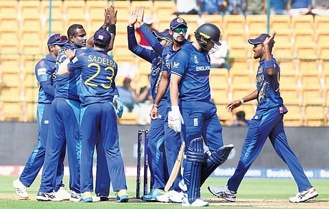 Sri Lanka players celebrate a wicket in their World Cup match against England at Chinnaswamy Stadium in Bengaluru on Thursday | Udayashankar S
