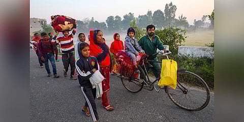 Villagers shift to a safer place following unprovoked firing by the Pakistan Rangers along the international border, in Arnia area of Jammu district. (Photo | PTI)