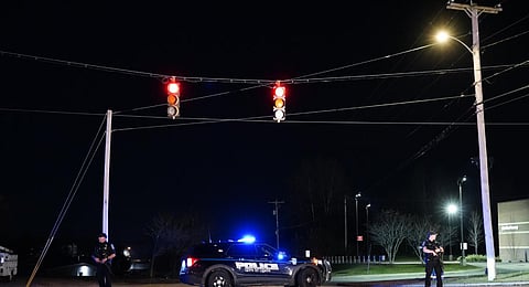 Police officers guard the road to a recycling facility where the body of Robert Card, the suspect in this week's mass shootings, was found. (Photo | AP)