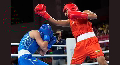India's Preeti and China's Chang Yuan compete during women's 50-54Kg semifinal boxing match at the 19th Asian Games in Hangzhou.(Photo | AP)