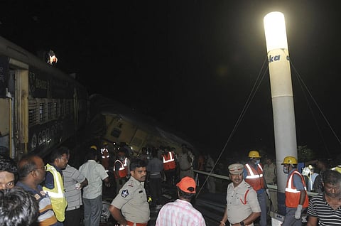 Rescuers stand at the site where two passenger trains collided in Andhra Pradesh, Sunday, Oct 29, 2023. (Photo | AP)