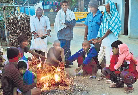 People huddle around a bonfire in Karimnagar on a chilly Sunday morning