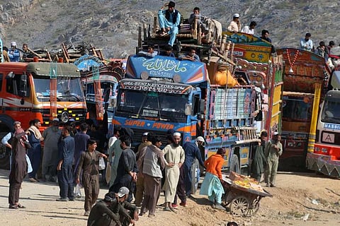 Afghan families onboard trucks wait for clearance to cross border through a border crossing point in Torkham, Pakistan | AP