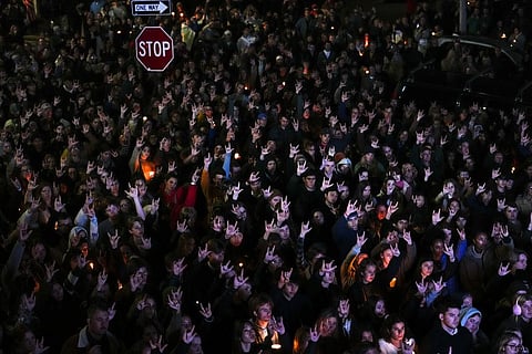 People gathered at a vigil for the victims of the Maine shootings.