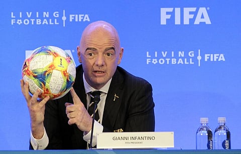 FIFA President Gianni Infantino holds a soccer ball as he speaks during a press conference after the FIFA Council Meeting, Friday, March 15, 2019, in Miami. | AP