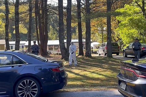 New York State police and crime scene investigators walk across the property in Milton, N.Y., where Craig Ross Jr. was found with Charlotte Sena, who he is suspected of kidnapping. (Photo | AP)