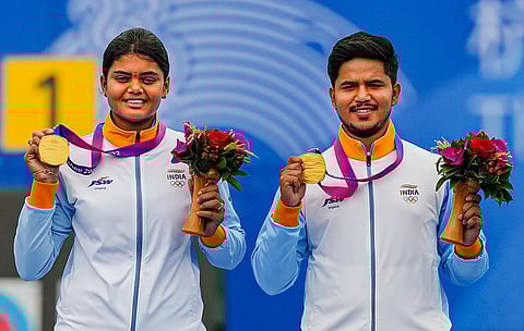 Ojas Pravin Deotale and Jyothi Surekha Vennam on the podium during the medal ceremony of mixed team compound archery event at the 19th Asian Games, in Hangzhou, China. (Photo | PTI)