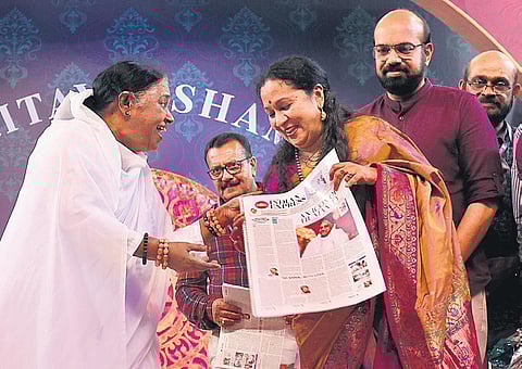 Mata Amritanandamayi releasing the eight-page special supplement, brought out by The New Indian Express, in connection with her 70th birthday, at the Amritanandamayi Ashram at Vallikavu in Kollam.