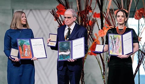 FILE | Natalia Pinchuk, left, on behalf of husband, Ales Bialiatski; Yan Rachinsky center, on behalf of the group Memorial; and Matviichuk pose with their Nobel Peace Prizes in Oslo. (AFP)