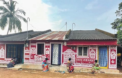 Lanjia Saura community members paint their homes in Rejingtal village. (Photo | Express)