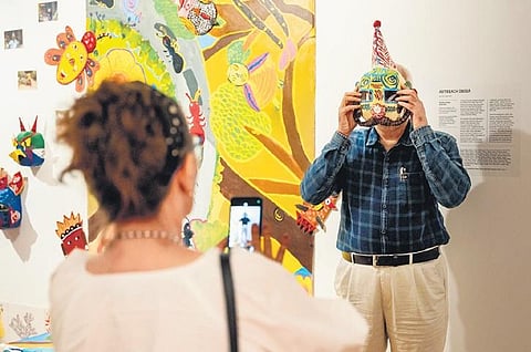 Inside, adults are keenly putting together pieces of jigsaw puzzles, while children make drawings of lizards and frogs.