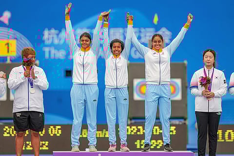 Gold medal winning India's Jyothi Surekha Vennam, Aditi Gopichand and Parneet Kaur celebrate on the podium during the presentation ceremony of team compound archery event. (Photo | PTI)