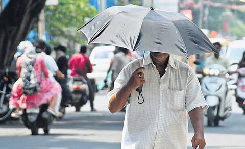 A man seen protecting himself from scorching heat in Vijayawada I Prasant Madugula