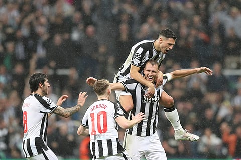 Newcastle's Dan Burn celebrates with his teammates after scoring his side's second goal. (Photo | AP)