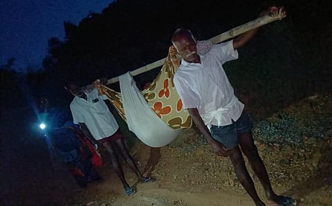 .A 22-year-old pregnant woman is carried in a doli due to the lack of proper road access for vehicles in Neknamalai, a hilllock at Tirupattur (Express photo)