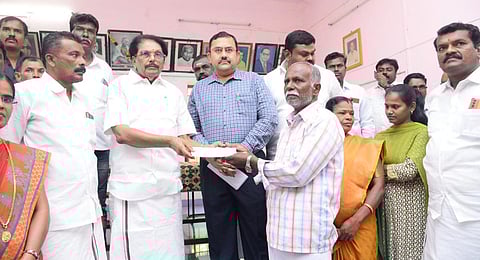 The Minsiter distributed cheques of Rs 2 lakh, announced by Chief Minister M K Stalin, to the families of seven victims of the Coonoor accident.(Photo | Posted by @KKSSRR_DMK on X )