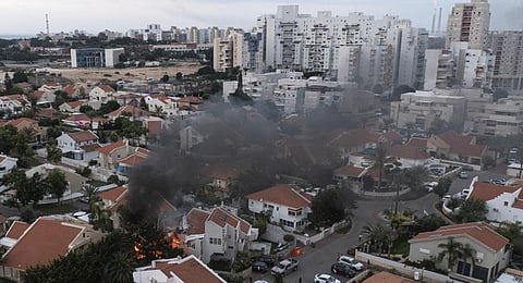 Smoke rises after a rocket fired from the Gaza Strip hit a house in Ashkelon, southern Israel. (Photo | AP)