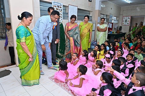 Higher Education Minister DR MC Sudhakar interacts with children at the SR Chandrasekhar Institute of Speech and Hearing on Friday. (Photo | Express)
