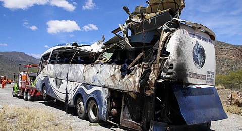 A crashed bus sits attached to a tow truck the side of the road near Villa de Tepelmeme, Oaxaca state, Mexico. (Photo | AP)