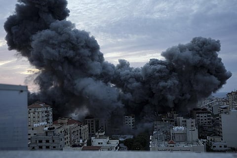 Smoke rises from an explosion on a Palestinian apartment tower following an Israeli air strike in Gaza City. (Photo | AP)