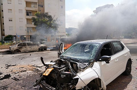 Cars are on fire after they were hit by rockets from the Gaza Strip in Ashkelon, Israel, on Saturday, Oct. 7, 2023. (Photo | AP)