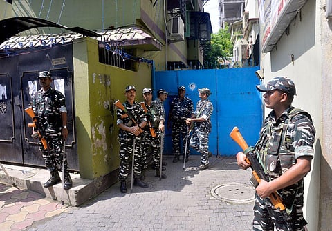 Paramilitary personnel stand guard at West Bengal Minister Firhad Hakim's residence, where the search is being conducted by the CBI in Kolkata on Sunday. (Photo | ANI)