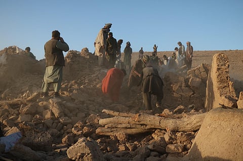 Afghan residents clear debris from a damaged house after an earthquake in Sarbuland village of Zendeh Jan district of Herat province on October 7, 2023.