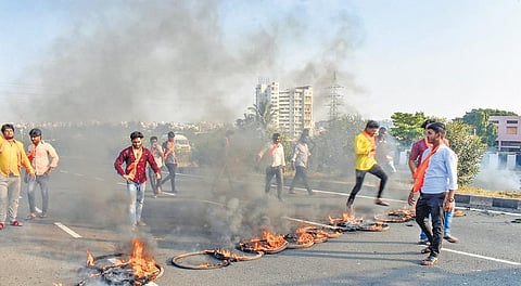 Agitators burn tyres during a protest for Maratha reservation in Solapur | pti