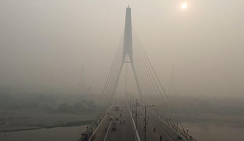 A thick layer of smog engulfs the Signature Bridge area as the air quality goes down to the 'Severe' category amid the rising air pollution, in New Delhi on Thursday. (Photo | ANI)