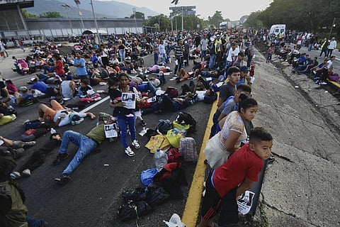 Migrants block the highway during their caravan through Huixtla, Mexico, Wednesday, Nov 8, 2023. (Photo | AP)