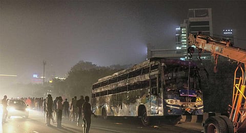 The charred bus after it suddenly caught fire en route to Delhi from Jaipur as it reached Gurugram, Wednesday, Nov. 8, 2023. (PTI)