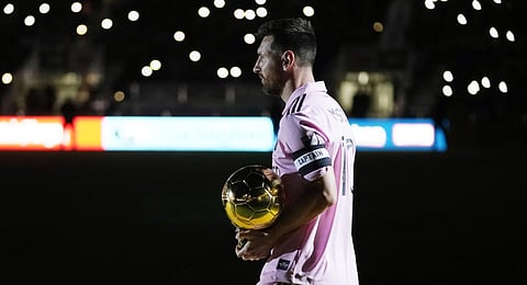 nter Miami forward Lionel Messi holds his Ballon d'Or trophy before the team's club friendly soccer match against New York City FC. (Photo | AP)