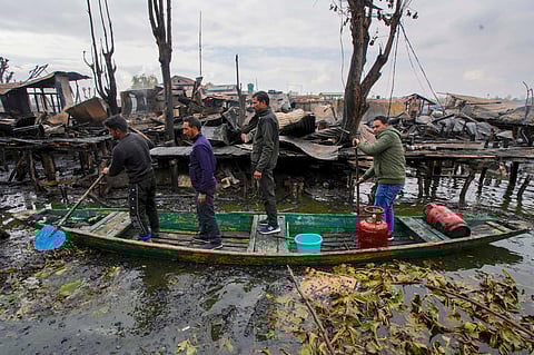 People secure their belongings following a fire in the tourist hub of Dal Lake in Srinagar (Photo | PTI)