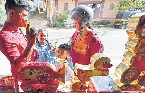 A family purchasing firecrackers and toy guns from a shop at Poozhikunnu in Thiruvananthapuram