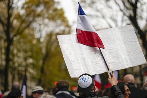 A demonstrator wearing a kippa and holding a French flag joins thousands who gathered for a march against antisemitism in Paris, France, Sunday, Nov. 12, 2023. (Photo | AP)