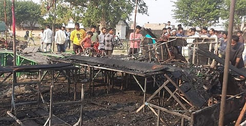 Locals at the site after a fire broke out at a shop and spread to six others, all selling firecrackers, in Gopalbagh on the outskirts of Mathura city, Uttar Pradesh, Sunday, Nov. 12, 2023. (PTI)