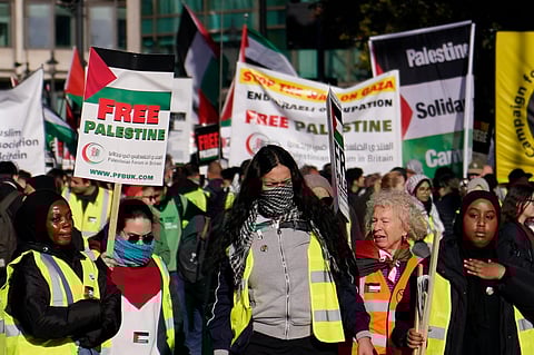 Protesters show placards during a pro-Palestinian protest in London on Saturday, November 11, 2023. (Photo | AP)