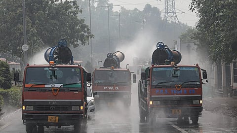 Mobile anti-smog guns spray water to curb air pollution in Delhi.