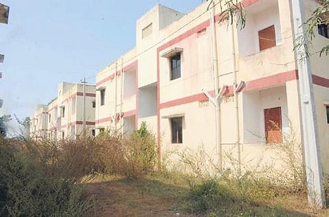 Double-bedroom housing units overgrown with plants at Urumadla village