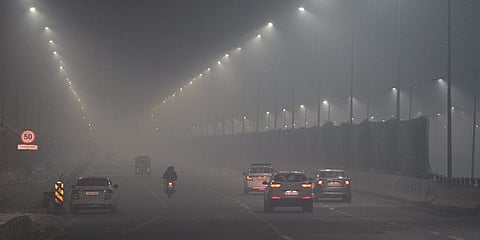 Vehicles move on a road amid low visibility due to smog on Diwali in New Delhi. (Photo | PTI)