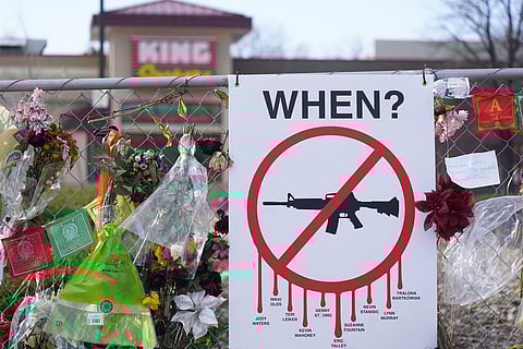 Tributes hang on the temporary fence surrounding the parking lot in front of a King Soopers grocery store in which 10 people died in a late March 2021 mass shooting. (Photo | AP)