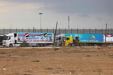 Trucks carrying aid cross into Rafah in the southern Gaza Strip on November 15, 2023 (AFP)