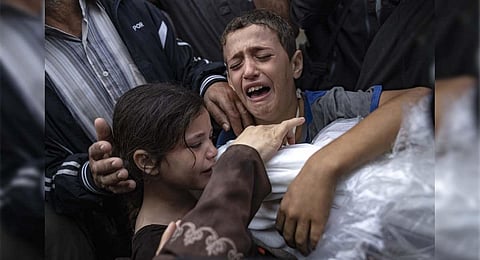 Palestinians mourn their relatives killed in the Israeli bombardment of the Gaza Strip, in the hospital on Tuesday. ( AP)