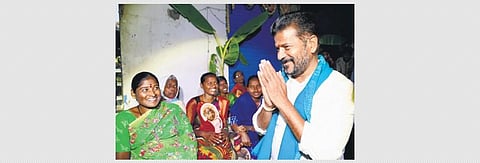 TPCC chief A Revanth Reddy greets women during campaigning at Isaipet village in Kamareddy Assembly constituency on Tuesday